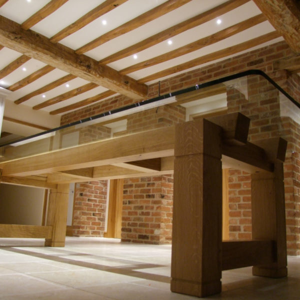 Bespoke wood beam dining table with glass top