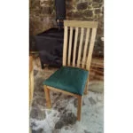 High back oak dining chair with green leather seat